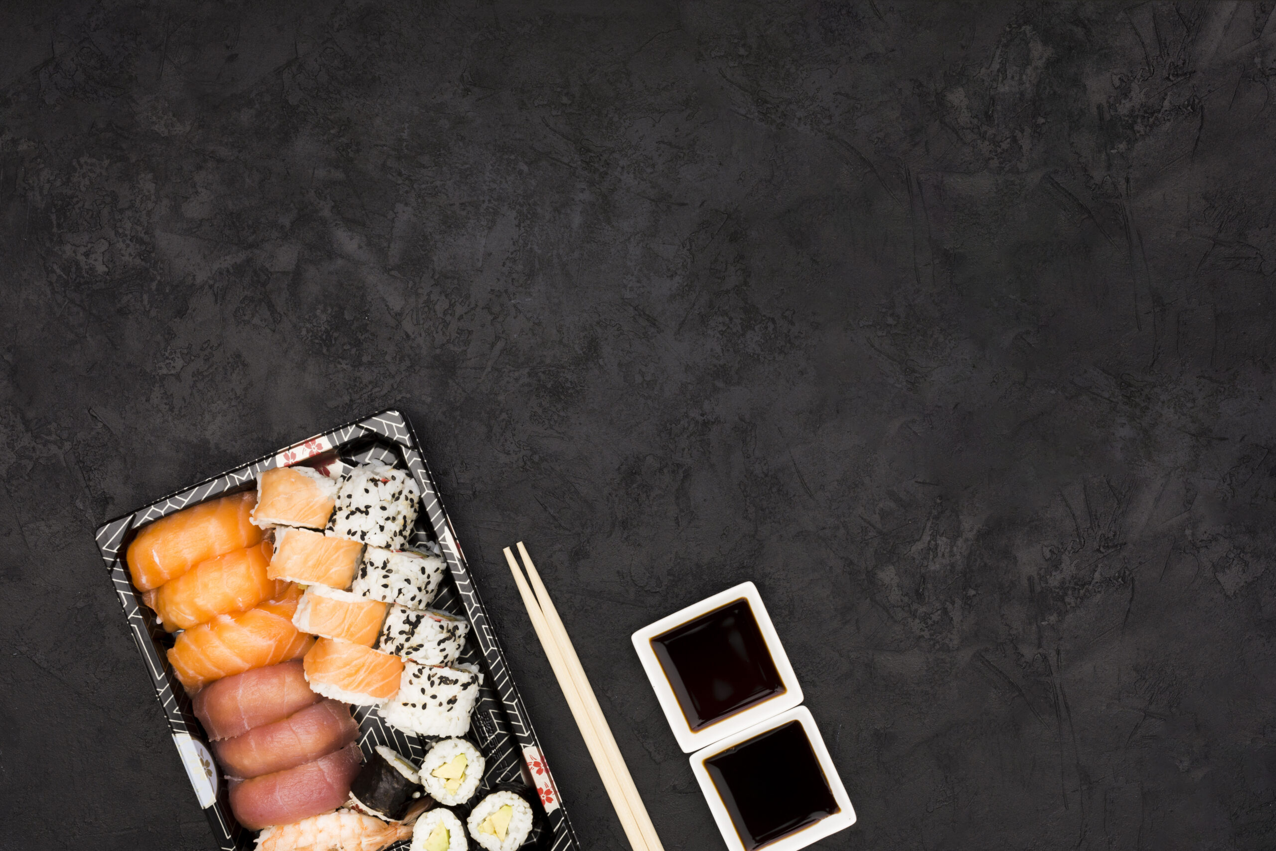 close-up-sashimi-sushi-plate-with-soya-sauce-black-surface